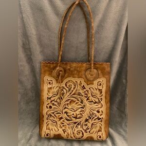 Brown leather floral Patricia Nash bag with gold cut outs and pink interior!